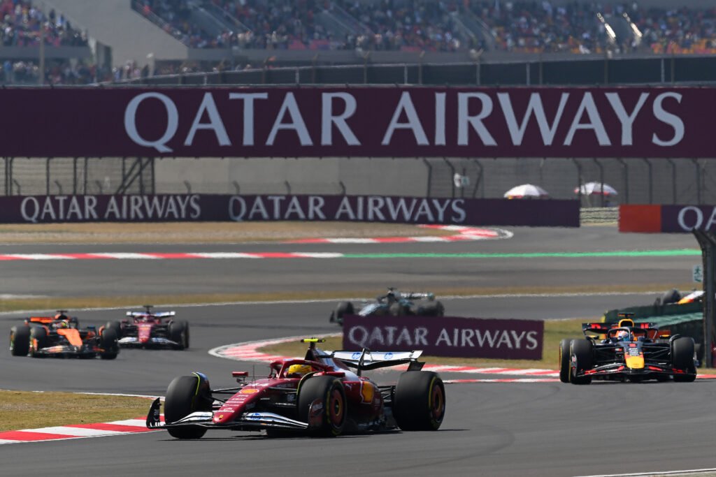 SHANGHAI, CHINA - MARCH 22: Lewis Hamilton of Great Britain driving the (44) Scuderia Ferrari SF-25 leads Max Verstappen of the Netherlands driving the (1) Oracle Red Bull Racing RB21, during the Sprint ahead of the F1 Grand Prix of China at Shanghai International Circuit on March 22, 2025 in Shanghai, China. Chinese F1 GP