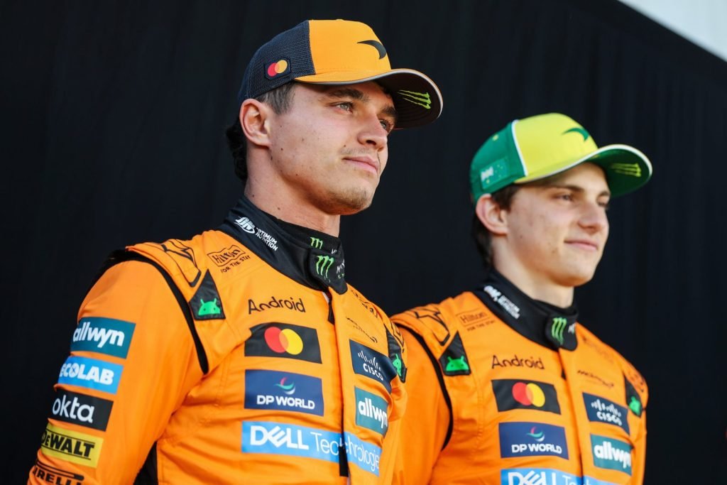MELBOURNE, AUSTRALIA - MARCH 13: Lando Norris of Great Britain and McLaren and Oscar Piastri of Australia and McLaren look on during previews ahead of the F1 Grand Prix of Australia at Albert Park Grand Prix Circuit on March 13, 2025 in Melbourne, Australia.