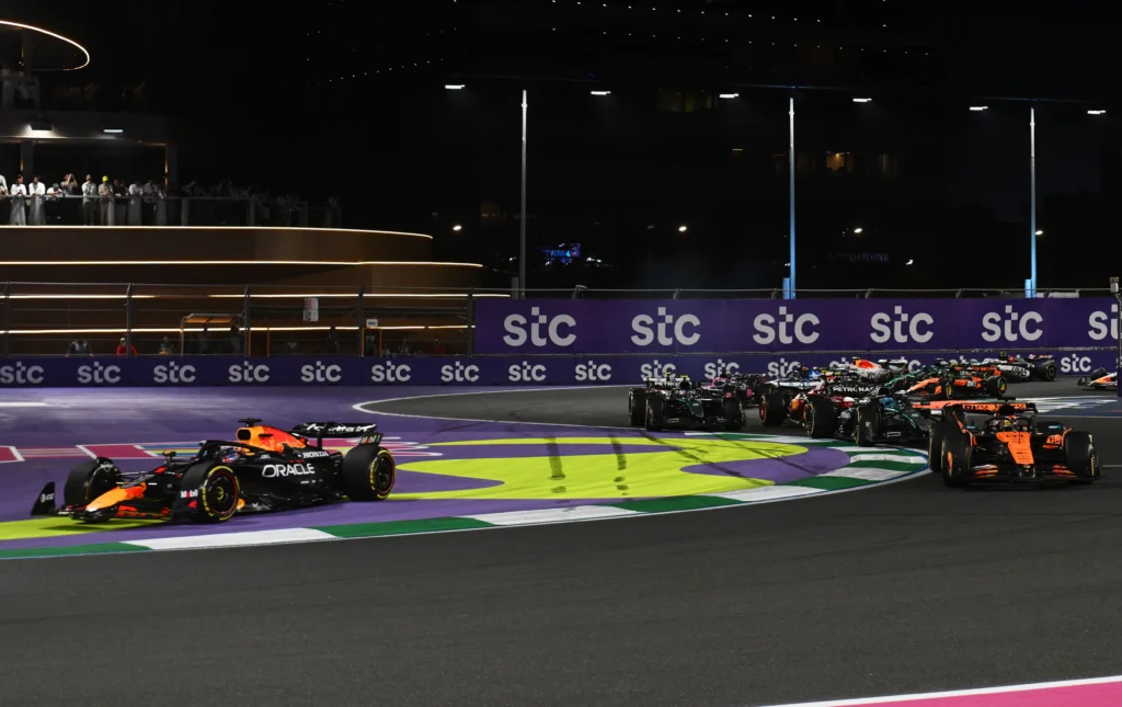 Max Verstappen of the Netherlands driving the (1) Oracle Red Bull Racing RB21 runs wide as Oscar Piastri of Australia driving the (81) McLaren MCL39 Mercedes leads George Russell of Great Britain driving the (63) Mercedes AMG Petronas F1 Team W16 and the rest of the field at the start during the F1 Grand Prix of Saudi Arabia at Jeddah Corniche Circuit on April 20, 2025 in Jeddah, Saudi Arabia. (Image Credit: Red Bull Content Pool/ Rudy Carezzevoli/Getty Images)