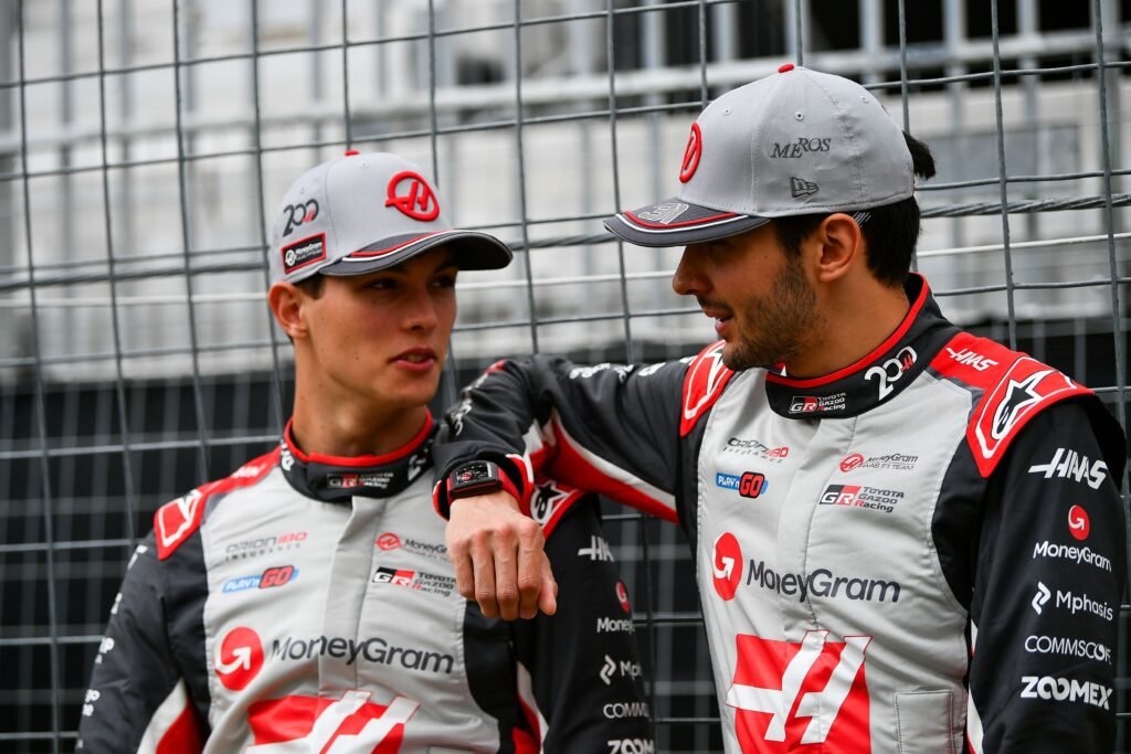 MoneyGram Haas F1 Team's Esteban Ocon and Oliver Bearman in commemorative suits as the team celebrates it's 200th race at the 2025 F1 Canadian GP.