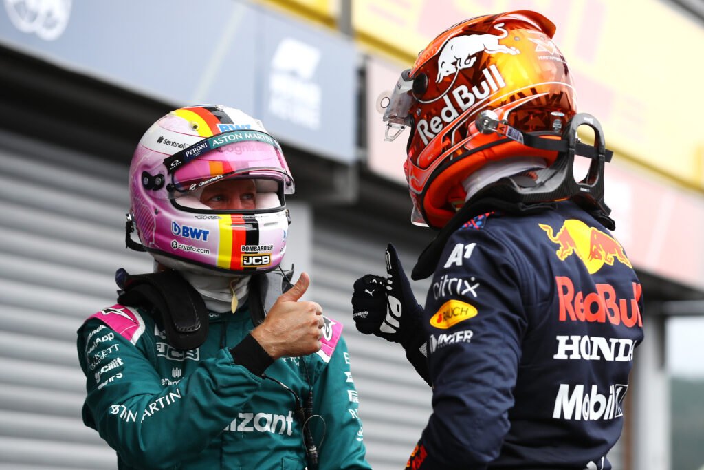 SPA, BELGIUM - AUGUST 28: Pole position qualifier Max Verstappen of Netherlands and Red Bull Racing celebrates with Sebastian Vettel of Germany and Aston Martin F1 Team in parc ferme during qualifying ahead of the F1 Grand Prix of Belgium at Circuit de Spa-Francorchamps on August 28, 2021 in Spa, Belgium.
