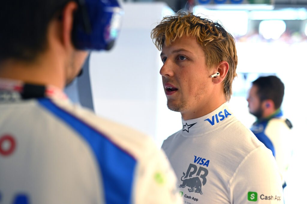 Liam Lawson at the 2025 F1 Austrian GP, speaking to an engineer.