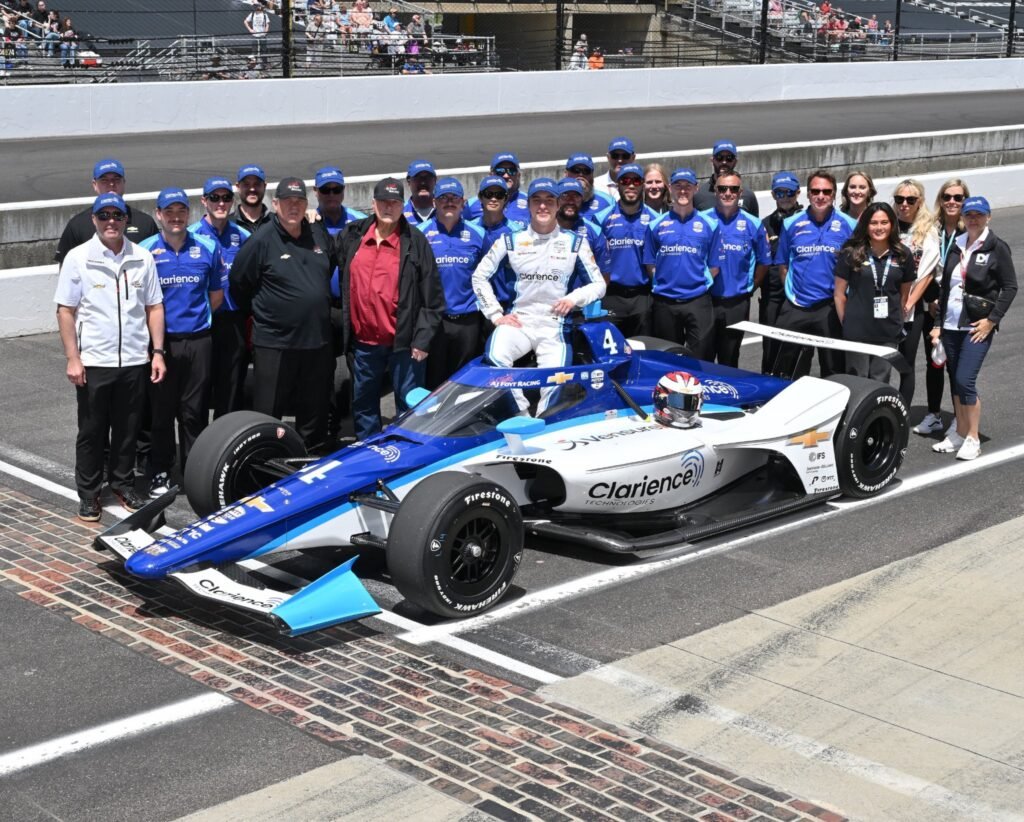 David Malukas and the AJ Foyt team posing on the grid ahead of the Indianapolis 500.