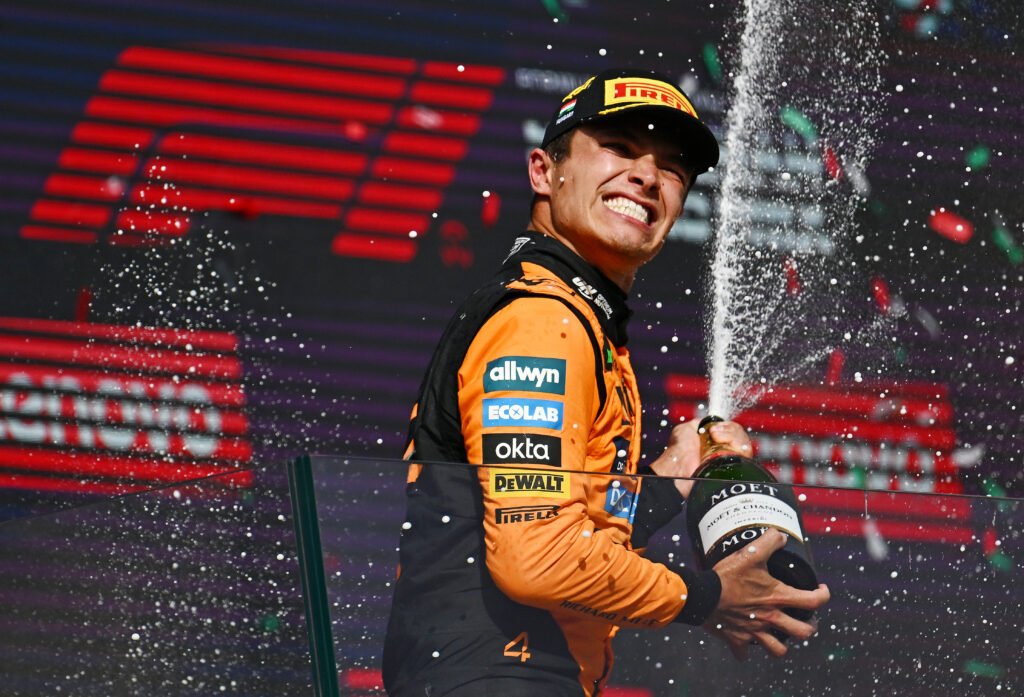 BUDAPEST, HUNGARY - AUGUST 03: Race winner Lando Norris of Great Britain and McLaren sprays the victory Champagne on the podium during the F1 Grand Prix of Hungary at Hungaroring on August 03, 2025 in Budapest, Hungary. (Photo by Guido De Bortoli/LAT Images) *** BESTPIX ***
